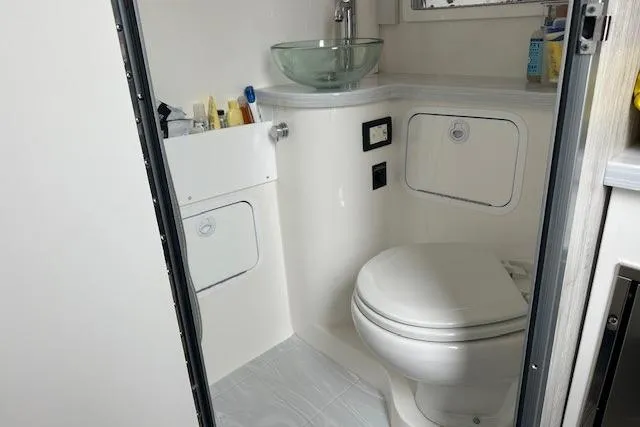 Slide: The Image of 2022 Regulator 41 boat bathroom with modern fixtures and compact design. - 22