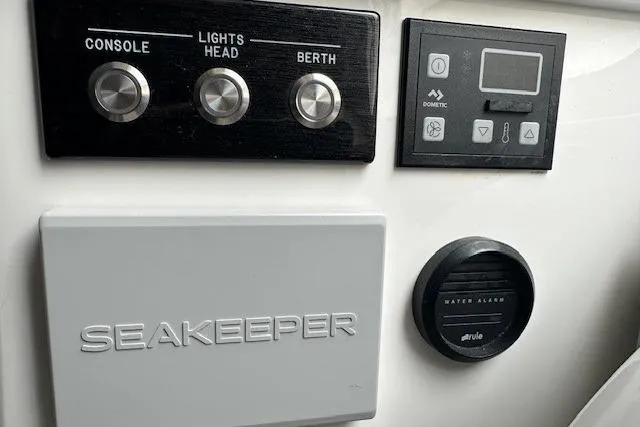 Slide: The Image of Control panel of a 2022 Regulator 41 boat featuring Seakeeper and water alarm. - 23