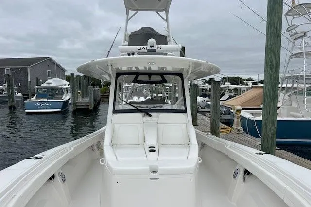 Slide: The Image of 2022 Regulator 41 boat docked at marina, featuring spacious deck and modern design. - 26