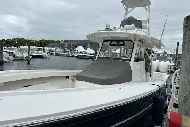 Slide: The Image of 2022 Regulator 41 boat docked in marina, featuring Garmin equipment and sleek design. - 29