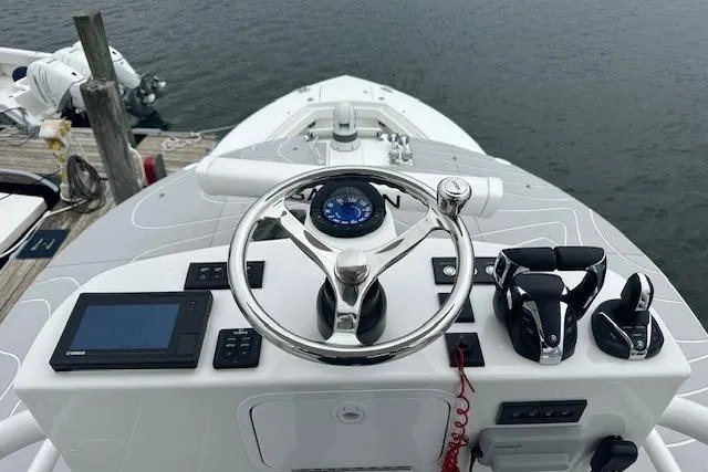 Slide: The Image of 2022 Regulator 41 boat helm with steering wheel, controls, and navigation display. - 30