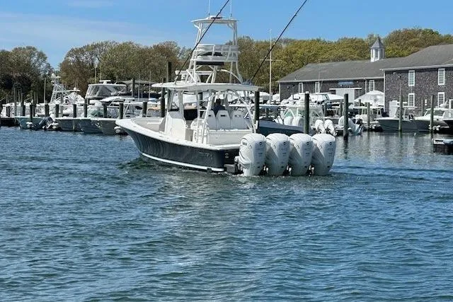 Slide: The Image of 2022 Regulator 41 boat with four engines docked in a marina. - 37