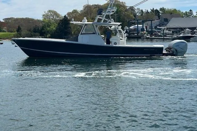 Slide: The Image of 2022 Regulator 41 boat cruising on a calm waterway with scenic background. - 39