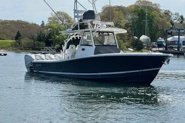 Slide: The Image of 2022 Regulator 41 boat on calm water, featuring sleek design and multiple engines. - 4