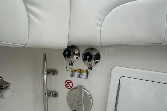 Slide: The Image of 2022 Regulator 41 boat interior with fuel caps and caution label. - 35