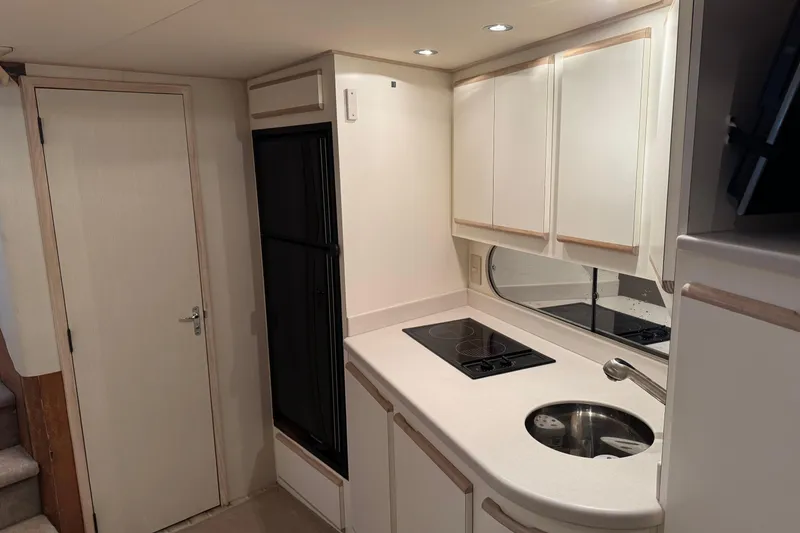 Slide: The Image of 1993 Blackfin 38 Combi yacht interior kitchen with stove, sink, and cabinets. - 10