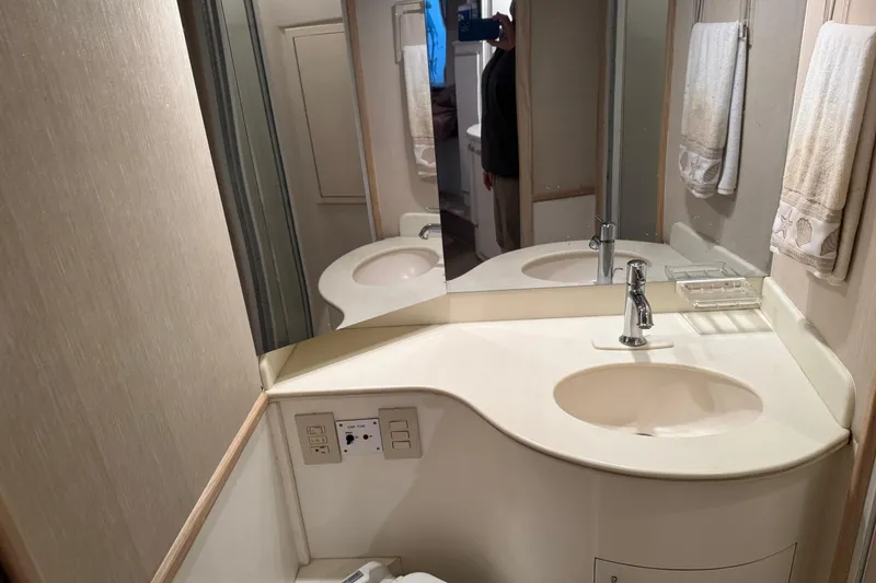 Slide: The Image of Bathroom vanity in a 1993 Blackfin 38 Combi boat, featuring a sink and mirror. - 12
