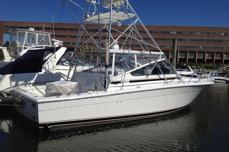 Slide: The Image of 1993 Blackfin 38 Combi boat docked in marina, featuring sleek design and fishing tower. - 3