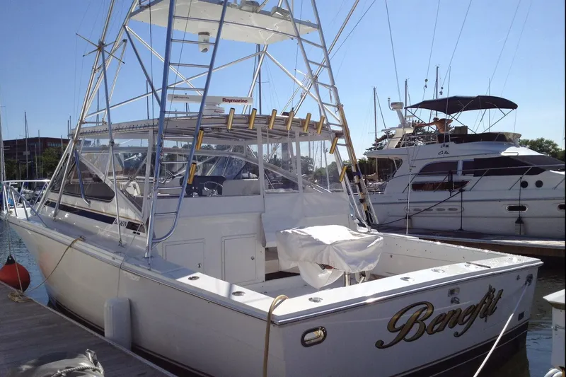 Slide: The Image of 1993 Blackfin 38 Combi boat docked at marina, featuring fishing equipment and sleek design. - 4