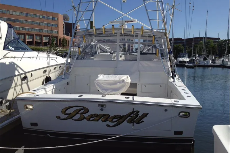 Slide: The Image of 1993 Blackfin 38 Combi boat docked in marina, rear view with name "Benefit." - 5