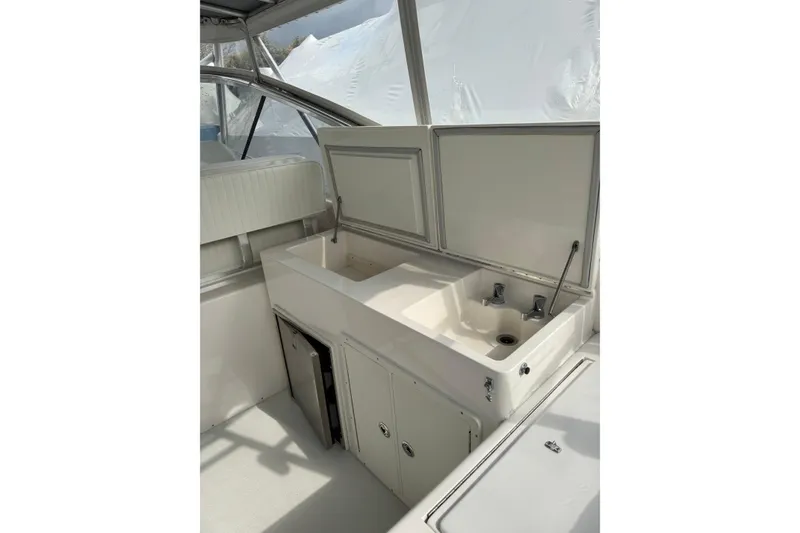Slide: The Image of Interior view of 1993 Blackfin 38 Combi boat with sink and storage area. - 7