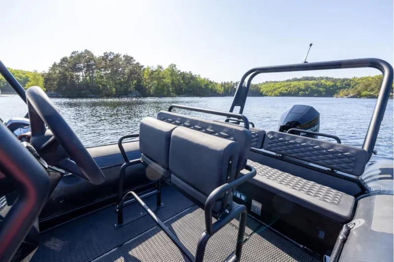 Slide: The Image of 2026 Highfield Patrol 700 boat interior on a scenic lake. - 7