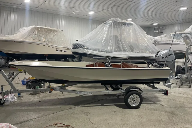 Slide: The Image of 1986 Boston Whaler 150 Super Sport boat on trailer in indoor storage. - 3