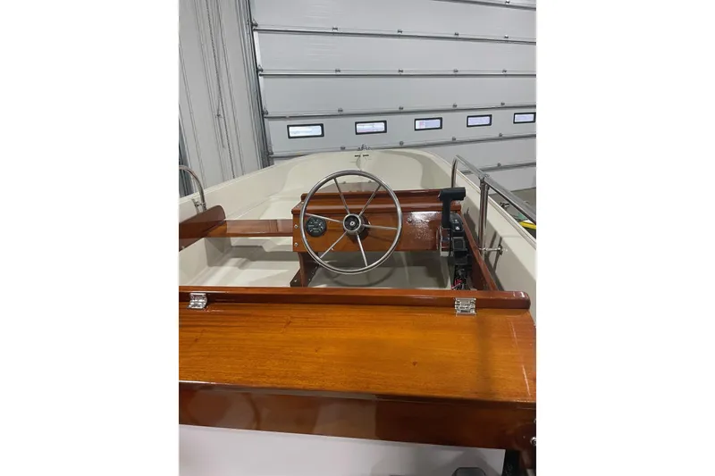 Slide: The Image of 1986 Boston Whaler 150 Super Sport boat interior with wooden steering wheel. - 6