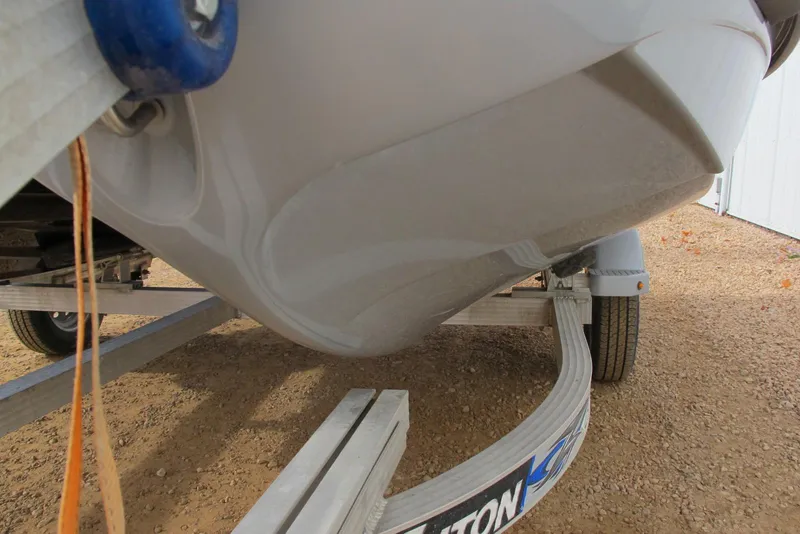 Slide: The Image of 2019 Sea-Doo GTX Limited 230 on trailer, close-up view of hull and wheel. - 2