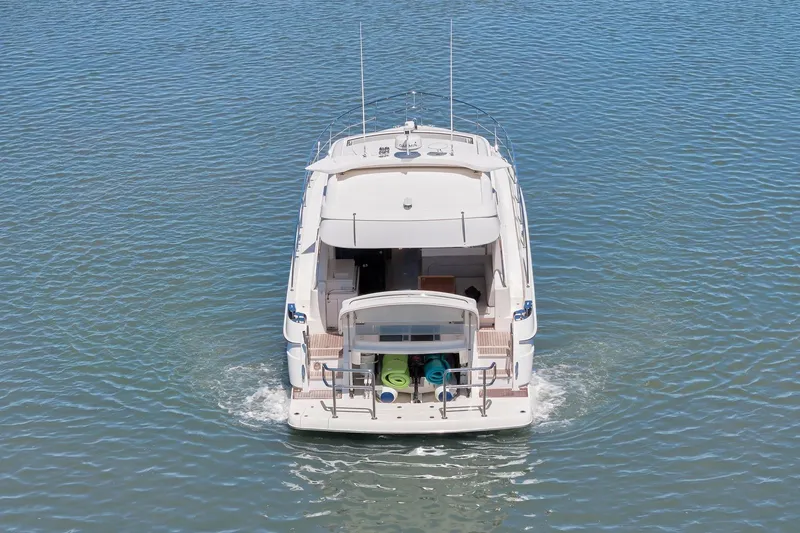 Slide: The Image of 2020 Riviera 4800 Sport Yacht cruising on calm blue waters. - 14