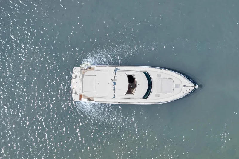 Slide: The Image of Aerial view of 2020 Riviera 4800 Sport Yacht cruising on water. - 15