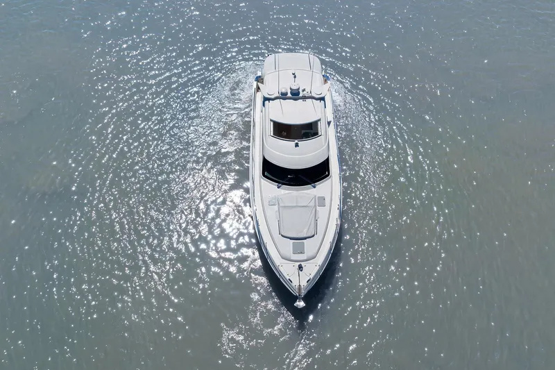 Slide: The Image of Aerial view of 2020 Riviera 4800 Sport Yacht cruising on sparkling water. - 16