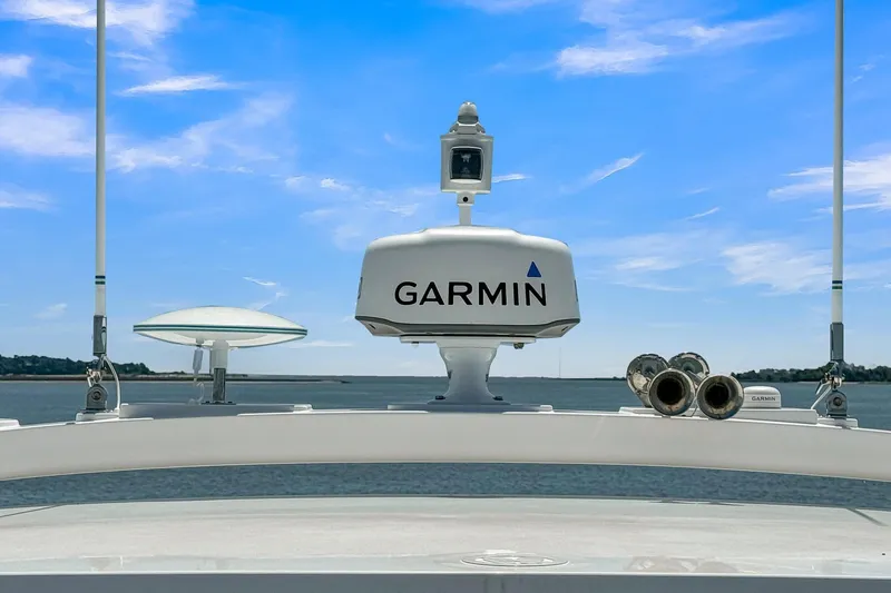 Slide: The Image of Riviera 4800 Sport Yacht 2020 with Garmin radar, antennas, and clear blue sky background. - 20