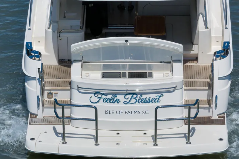 Slide: The Image of 2020 Riviera 4800 Sport Yacht, rear view, named "Feelin' Blessed," Isle of Palms, SC. - 21