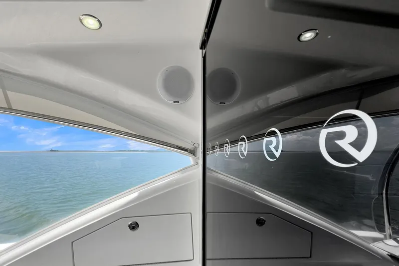 Slide: The Image of 2020 Riviera 4800 Sport Yacht interior with ocean view and logo reflection. - 24