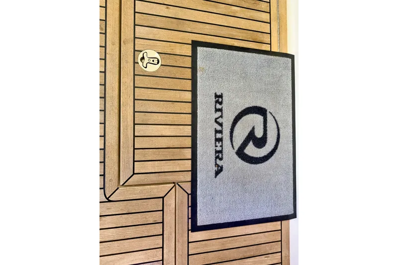 Slide: The Image of Gray Riviera doormat on wooden deck of 2020 Riviera 4800 Sport Yacht. - 28