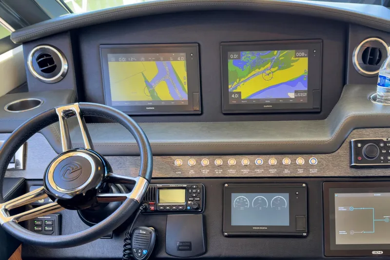 Slide: The Image of Helm of 2020 Riviera 4800 Sport Yacht with navigation screens and controls. - 29