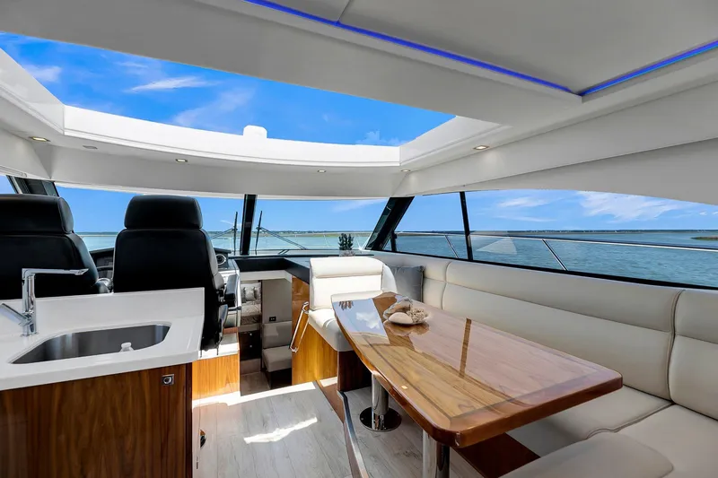 Slide: The Image of Interior of 2020 Riviera 4800 Sport Yacht with luxurious seating and ocean view. - 35