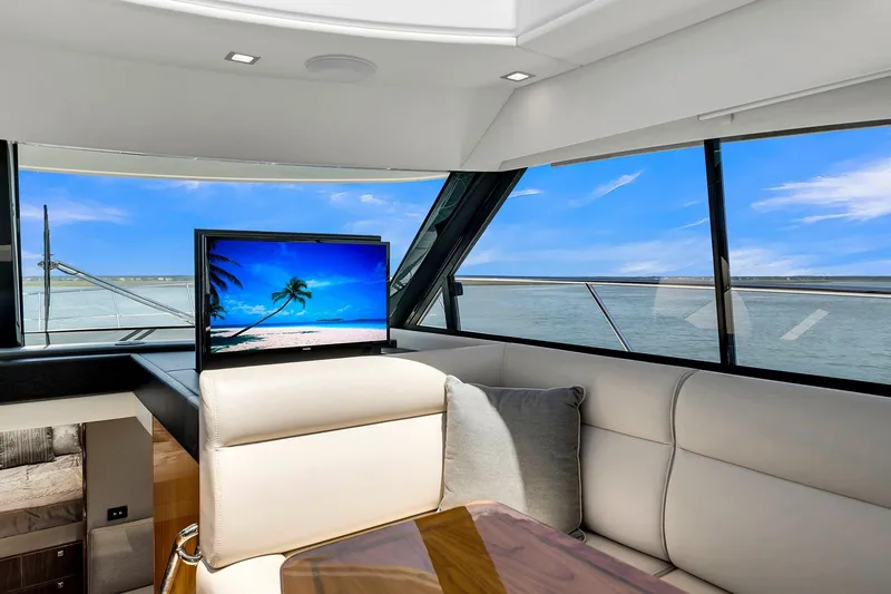 Slide: The Image of Luxurious interior of 2020 Riviera 4800 Sport Yacht with ocean view and TV. - 38