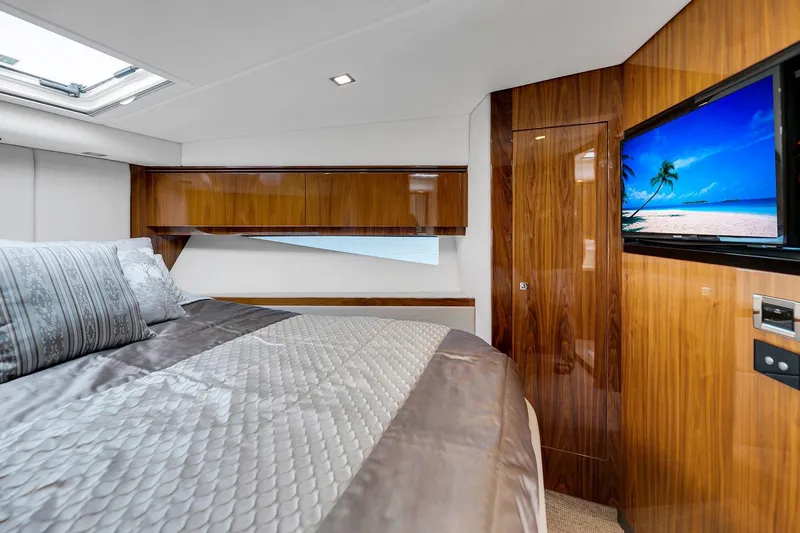 Slide: The Image of Luxurious interior of 2020 Riviera 4800 Sport Yacht with elegant wood finishes and cozy bedding. - 46
