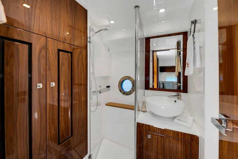 Slide: The Image of Luxurious bathroom in 2020 Riviera 4800 Sport Yacht with wood accents and modern fixtures. - 47