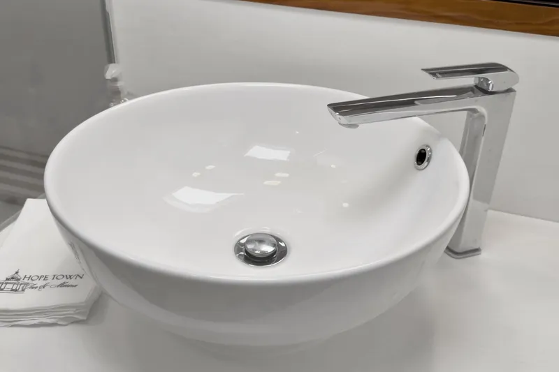 Slide: The Image of Modern white sink with sleek chrome faucet on Riviera 4800 Sport Yacht, 2020 model. - 49