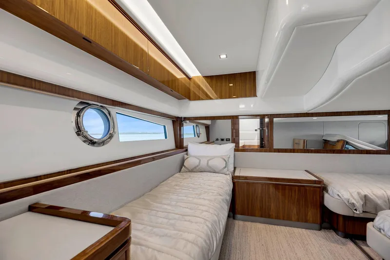 Slide: The Image of Luxurious interior of 2020 Riviera 4800 Sport Yacht with elegant wood finishes and cozy bedding. - 54