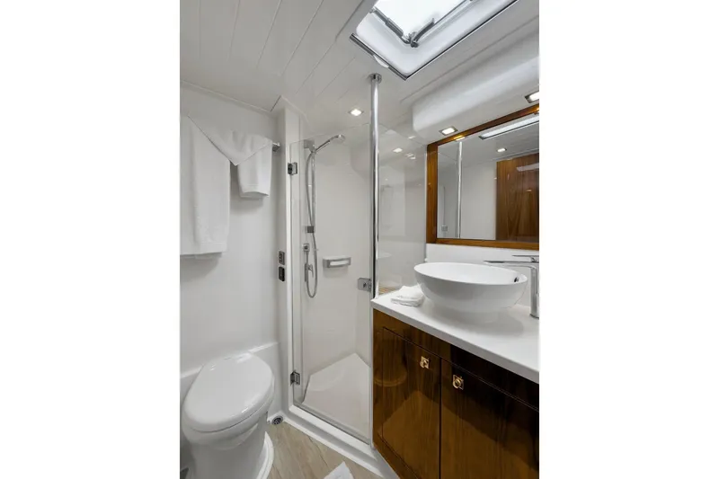 Slide: The Image of Luxurious bathroom in 2020 Riviera 4800 Sport Yacht with modern fixtures and elegant design. - 57