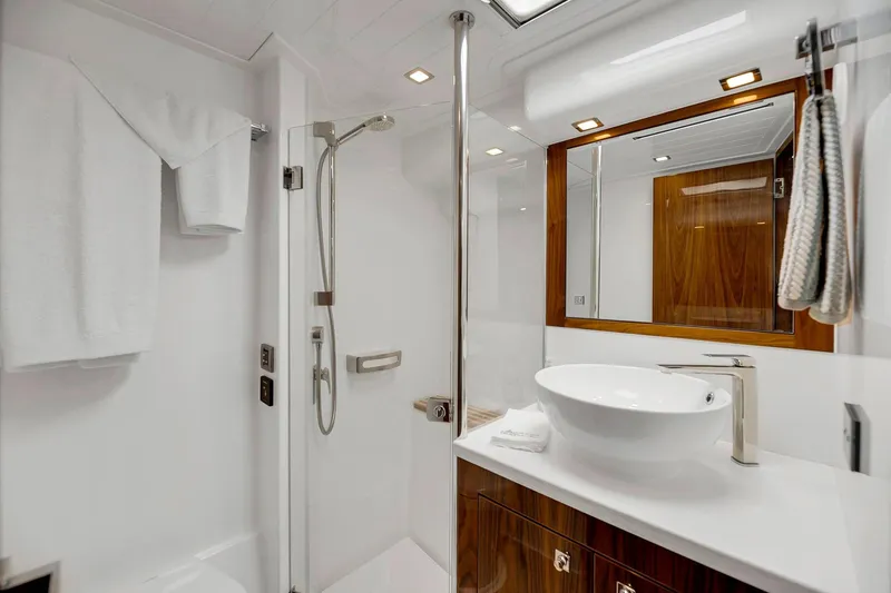 Slide: The Image of Luxurious bathroom in 2020 Riviera 4800 Sport Yacht with modern fixtures and elegant design. - 58