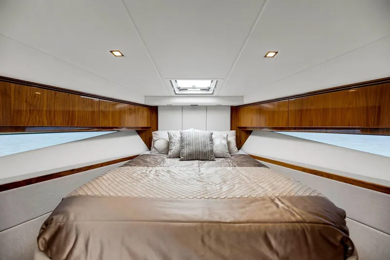 Slide: The Image of Luxurious bedroom interior of 2020 Riviera 4800 Sport Yacht with elegant wood finishes. - 63