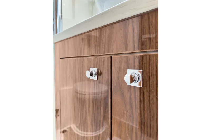 Slide: The Image of Wooden cabinet with chrome handles in 2020 Riviera 4800 Sport Yacht interior. - 64