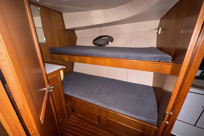 Slide: The Image of Cozy wooden cabin with bunk beds in a 1990 Symbol 53 Sedan. - 10