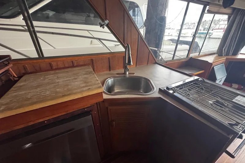 Slide: The Image of Interior of a 1990 Symbol 53 Sedan yacht with kitchen sink and stove. - 8
