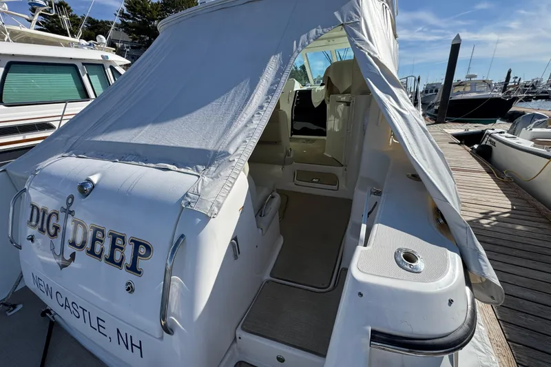 Slide: The Image of 2008 Tiara Yachts 3900 Sovran docked, featuring covered entrance and "Dig Deep" name. - 10