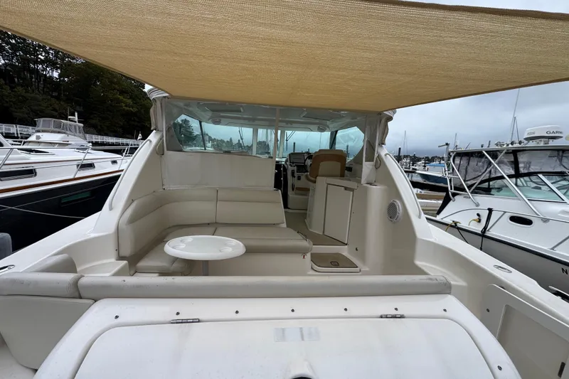 Slide: The Image of 2008 Tiara Yachts 3900 Sovran with spacious deck and seating, docked at marina. - 12