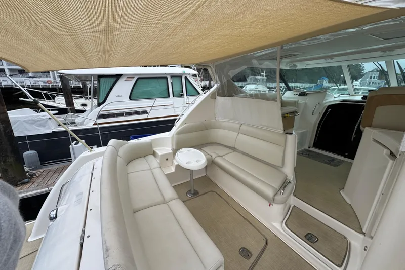 Slide: The Image of 2008 Tiara Yachts 3900 Sovran interior with beige seating and canopy at marina. - 13