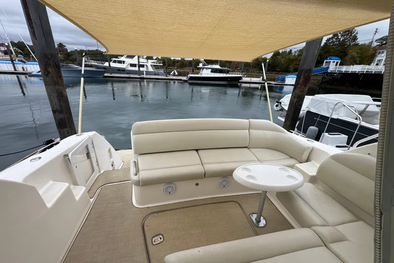 Slide: The Image of 2008 Tiara Yachts 3900 Sovran with beige seating and table, docked at marina. - 14