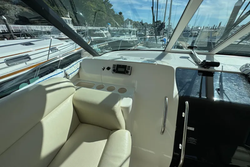 Slide: The Image of 2008 Tiara Yachts 3900 Sovran cockpit with beige seating and marina view. - 21