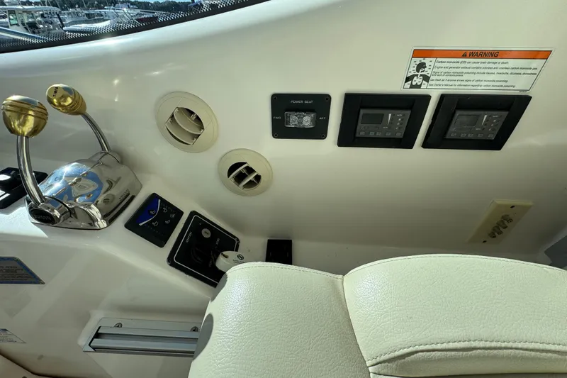 Slide: The Image of 2008 Tiara Yachts 3900 Sovran helm controls with gauges and switches. - 26