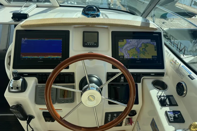 Slide: The Image of 2008 Tiara Yachts 3900 Sovran helm with dual Garmin displays and wooden steering wheel. - 27