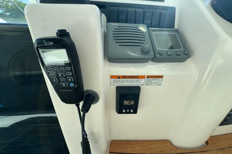 Slide: The Image of 2008 Tiara Yachts 3900 Sovran dashboard with Icom radio and navigation controls. - 29