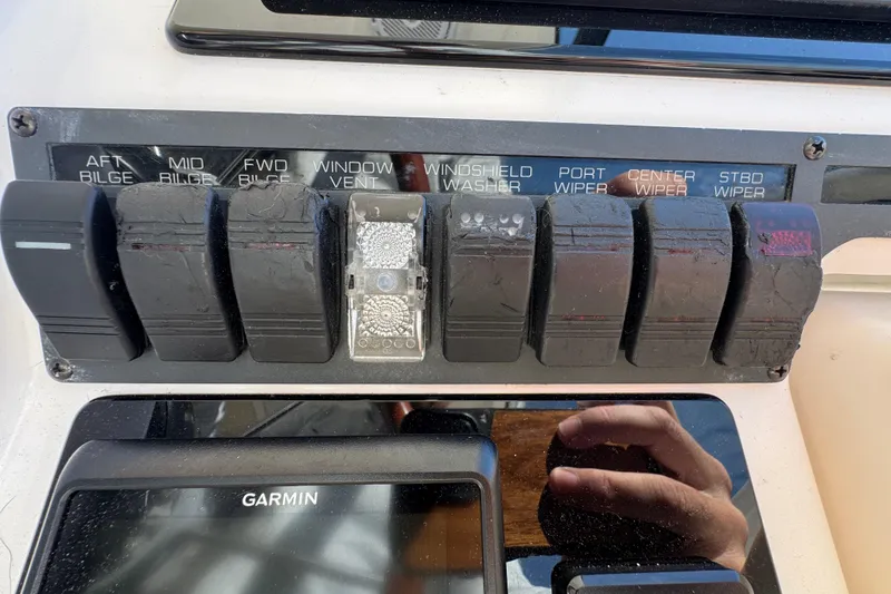 Slide: The Image of Control panel of a 2008 Tiara Yachts 3900 Sovran with labeled switches and Garmin display. - 31