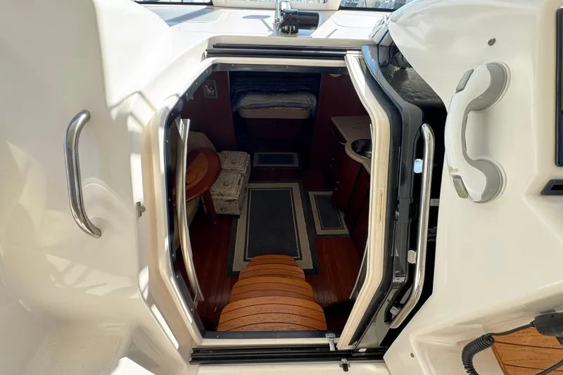 Slide: The Image of 2008 Tiara Yachts 3900 Sovran cabin entrance with wooden steps and interior view. - 37