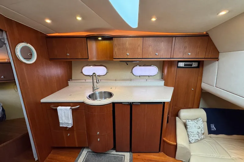 Slide: The Image of 2008 Tiara Yachts 3900 Sovran interior with wooden cabinetry and compact kitchen area. - 40